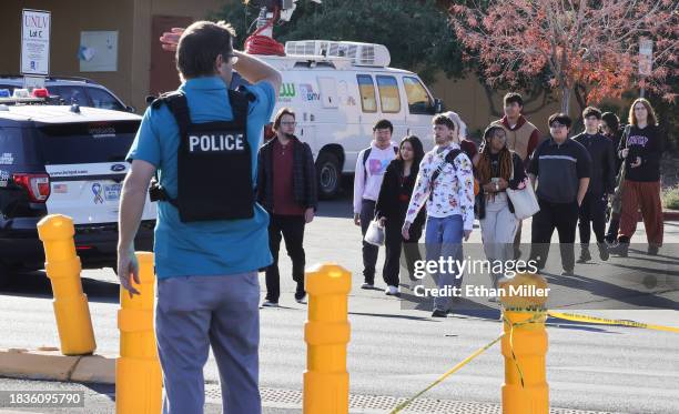 People cross Maryland Parkway as they are led off of the UNLV campus after a shooting on December 06, 2023 in Las Vegas, Nevada. According to Las...