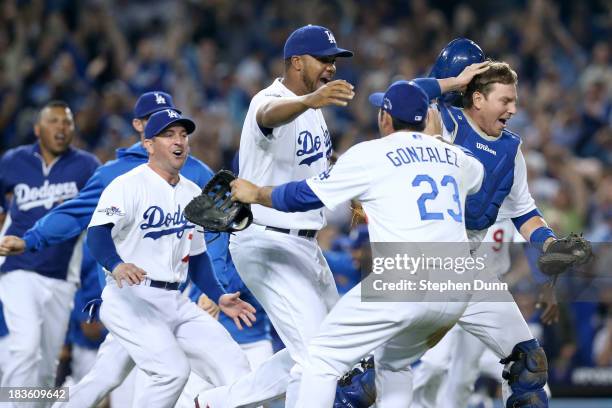 Adrian Gonzalez, A.J. Ellis and Kenley Jansen of the Los Angeles Dodgers celebrate after the Dodgers defeat the Atlanta Braves 4-3 in Game Four of...