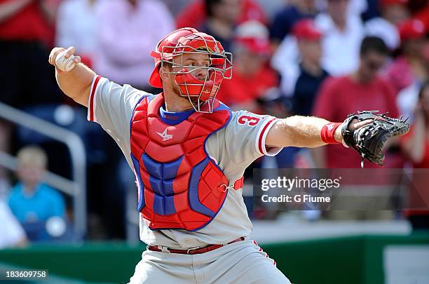 Erik Kratz of the Philadelphia Phillies throws the ball to second base against the Washington Nationals at Nationals Park on September 15, 2013 in...