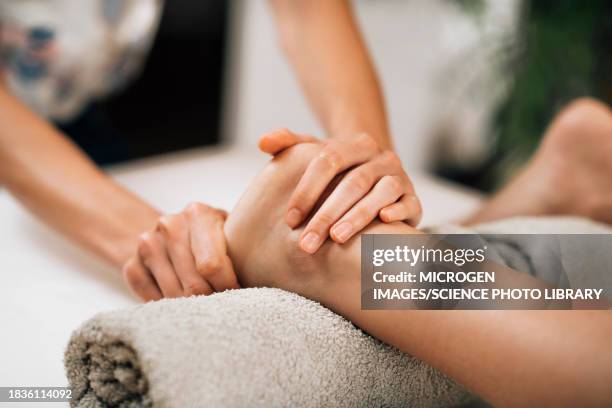 ayurvedic foot massage - two human feet stock pictures, royalty-free photos & images