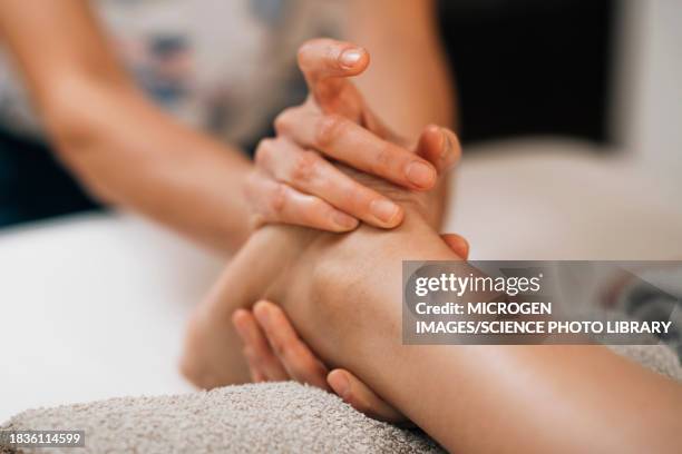 ayurvedic foot massage - two human feet stock pictures, royalty-free photos & images