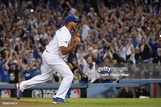 Kenley Jansen of the Los Angeles Dodgers celebrates after the Dodgers defeat the Atlanta Braves 4-3 in Game Four of the National League Division...