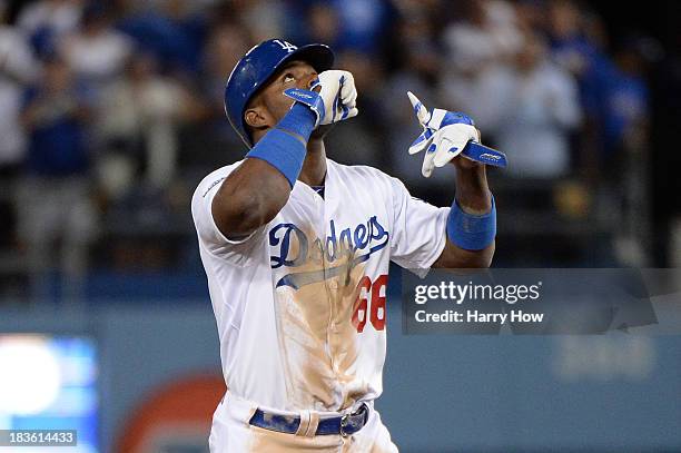 Yasiel Puig of the Los Angeles Dodgers celebrates on second base after hitting a double in the eighth inning against the Atlanta Braves in Game Four...