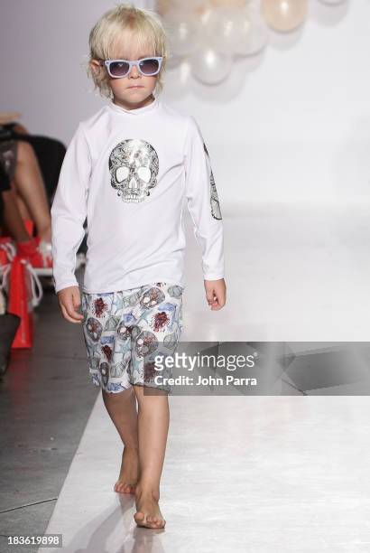 Model walks the runway during the Aracely Santamaria preview at the Parsons The School For Design at petiteParade NY Kids Fashion Week in...