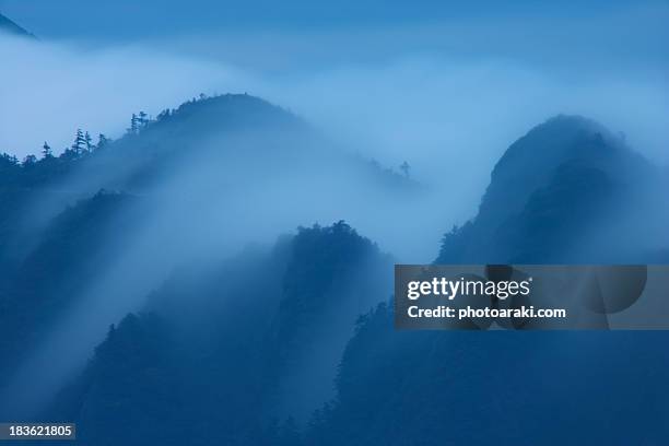 clouds over mountain range - saijo ehime stock pictures, royalty-free photos & images