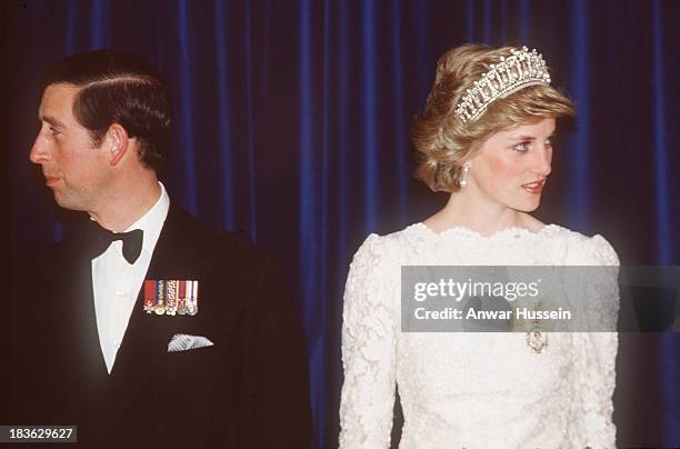 Prince Charles, Prince of Wales and Diana, Princess of Wales, wearing a cream lace gown with a scalloped neckline designed by Murray Arbeid and the...
