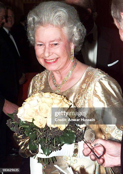 Queen Elizabeth ll, wearing a gold dress for the occasion, arrives at the Festival Hall for a Royal Gala to celebrate her Golden Wedding Anniversary...