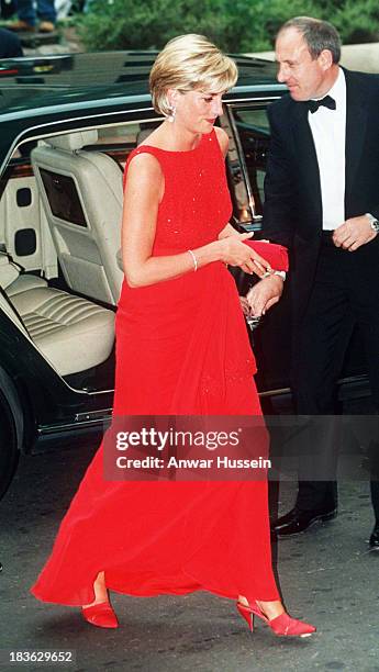 Diana, Princess of Wales wears a red Jacques Azagury dress as she attends a fund raising dinner for the American Red Cross on June 17, 1997 in...