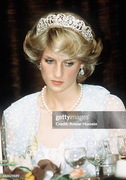 Diana, Princess of Wales, wearing a pale blue dress with polka dots designed by Elizabeth and David Emanuel and the Spencer family tiara, attends a...