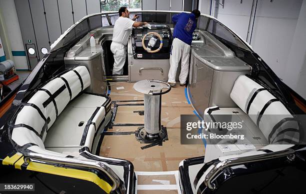 Shipwrights work on the instrument control deck onboard a part complete Riva Rivarama Super luxury yacht, manufactured by Ferretti Group, at the...
