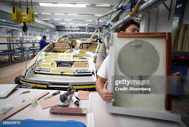 Shipwright works on a part for a Riva Rivarama Super luxury yacht, manufactured by Ferretti Group, ahead of fitting at the company's shipyard in...