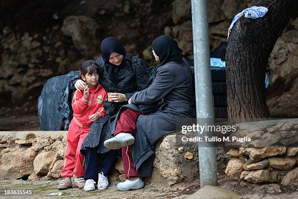 Immigrants are detained after their arrival in the temporary shelter Center on October 8, 2013 in Lampedusa, Italy. The search for bodies continues...