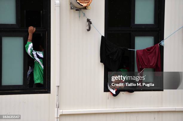 Immigrants are detained after their arrival in the temporary shelter Center on October 8, 2013 in Lampedusa, Italy. The search for bodies continues...