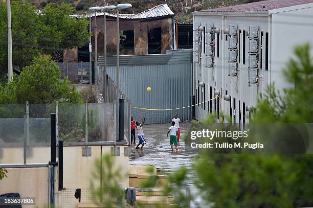 Immigrants are detained after their arrival in the temporary shelter Center on October 8, 2013 in Lampedusa, Italy. The search for bodies continues...