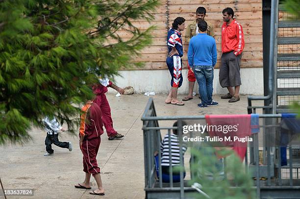 Immigrants are detained after their arrival in the temporary shelter Center on October 8, 2013 in Lampedusa, Italy. The search for bodies continues...