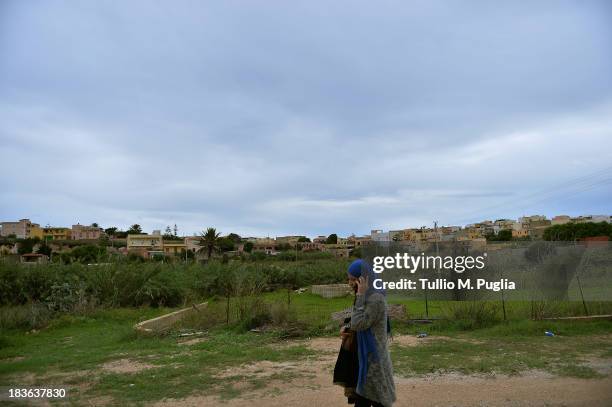 Immigrants are seen outside of the temporary shelter Center , where they are detained after their arrival on the island on October 8, 2013 in...