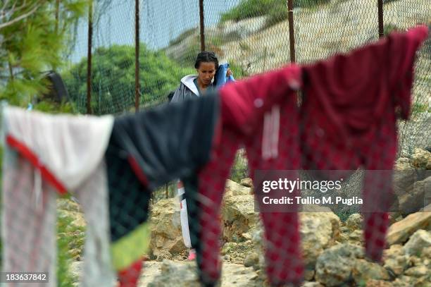 Immigrants are detained after their arrival in the temporary shelter Center on October 8, 2013 in Lampedusa, Italy. The search for bodies continues...