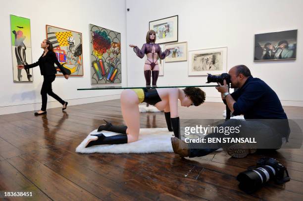 Photographer takes pictures during a photocall for an exhibition entitled 'When Britain Went Pop' at Christie's auction house in London, on October...