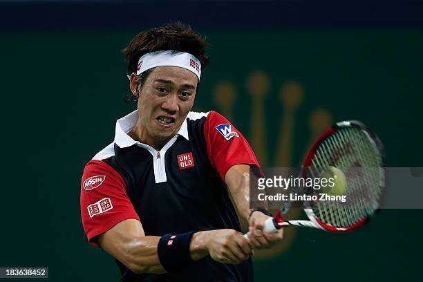 Kei Nishikori of Japan returns a shot to Grigor Dimitrov of Bulgaria during day two of the Shanghai Rolex Masters at the Qi Zhong Tennis Center on...