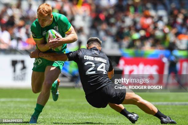 Ireland's Gavin Mullin is tackled by New Zealand's Tepaea Cook-Savage during the men's HSBC World Rugby Sevens Series 2023 quarter final match...