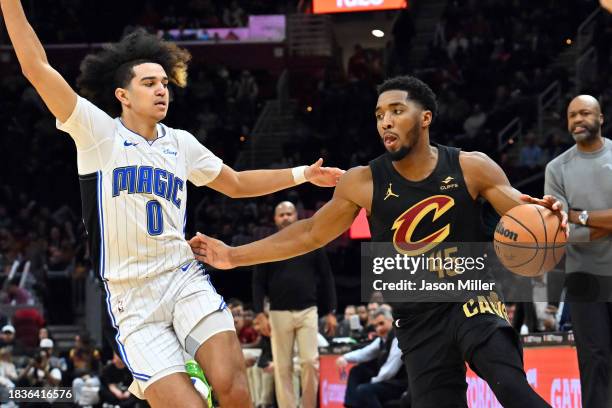 Donovan Mitchell of the Cleveland Cavaliers drives to the basket around Anthony Black of the Orlando Magic during the third quarter at Rocket...