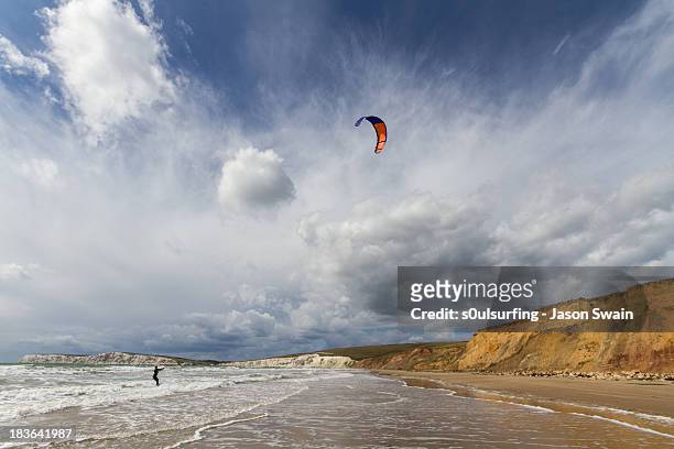 kitesurfing at compton bay, isle of wight - isle of wight beach stock pictures, royalty-free photos & images