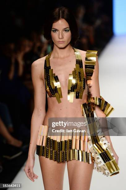 Model walks the runway at the Red Beard By Tanju Babacan show during Mercedes-Benz Fashion Week Istanbul s/s 2014 presented by American Express on...