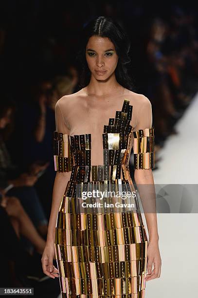 Model walks the runway at the Red Beard By Tanju Babacan show during Mercedes-Benz Fashion Week Istanbul s/s 2014 presented by American Express on...