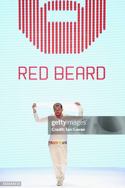 Fashion designer Tanju Babacan walks the runway at the Red Beard By Tanju Babacan show during Mercedes-Benz Fashion Week Istanbul s/s 2014 presented...