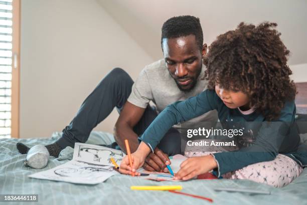 african american man and boy playing with coloring pencils - widower stock pictures, royalty-free photos & images