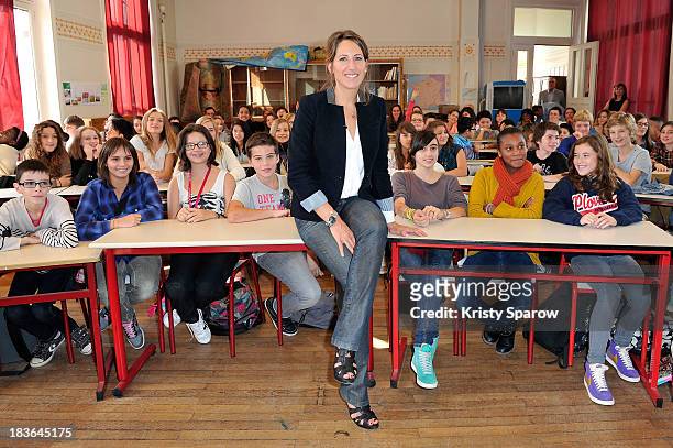 Maud Fontenoy poses with school children during her launch to supply teaching equipment for schools at Lycee Jules Ferry in Paris on October 8, 2013...