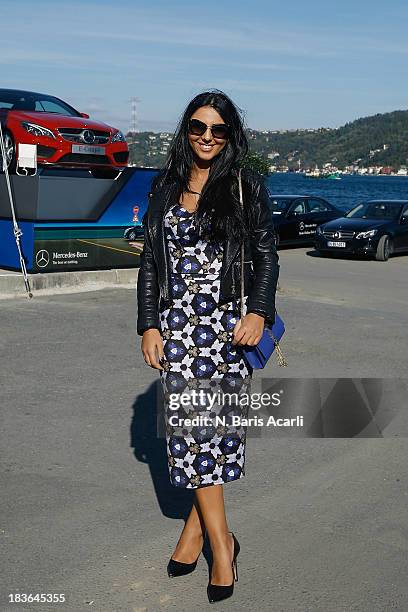 Duygu Senyurek wears a Guhur Gunes dress, Zara jacket and shoes, Miu Miu glasses and YSL bag during Mercedes-Benz Fashion Week Istanbul s/s 2014...