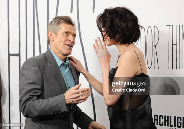 Willem Dafoe and Margaret Qualley attend the "Poor Things" premiere at DGA Theater on December 06, 2023 in New York City.