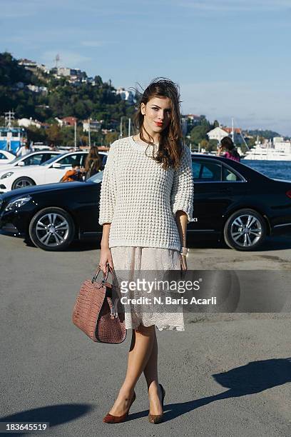 Meric Kucuk wears a vintage dress, a BSL knitwear, Hotic shoes and Emporio Armani bag during Mercedes-Benz Fashion Week Istanbul s/s 2014 presented...
