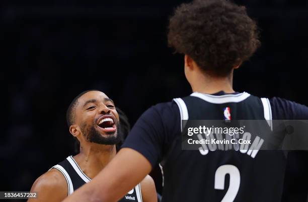 Mikal Bridges of the Brooklyn Nets reacts with Cameron Johnson after their 114-113 win over the Atlanta Hawks at State Farm Arena on December 06,...