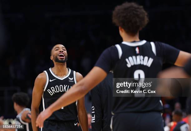 Mikal Bridges of the Brooklyn Nets reacts with Cameron Johnson after their 114-113 win over the Atlanta Hawks at State Farm Arena on December 06,...