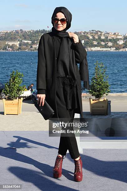 Kuaybe Gider wears a Zara jacket, her own designed top, Gap pants and an Iperkol bag during Mercedes-Benz Fashion Week Istanbul s/s 2014 presented by...