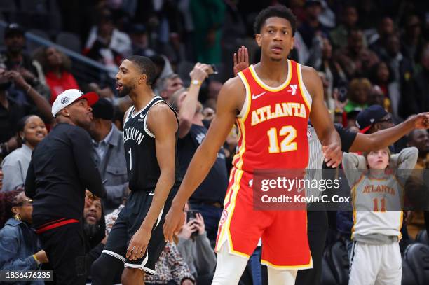 Mikal Bridges of the Brooklyn Nets reacts after hitting what ends up being the game-winning basket against De'Andre Hunter of the Atlanta Hawks in...