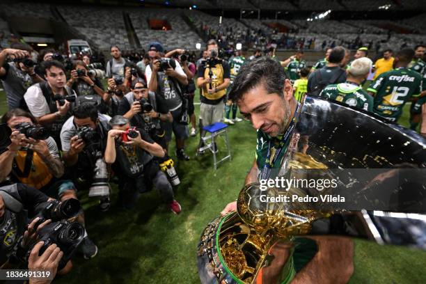 Abel Ferreira coach of Palmeiras celebrates with the champion trophy after winning the match between Cruzeiro and Palmeiras as part of Brasileirao...