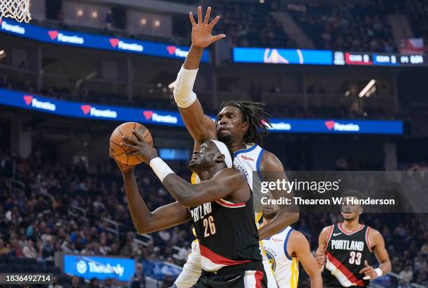 Duop Reath of the Portland Trail Blazers is fouled on a drive to the basket by Kevon Looney of the Golden State Warriors during the first quarter at...