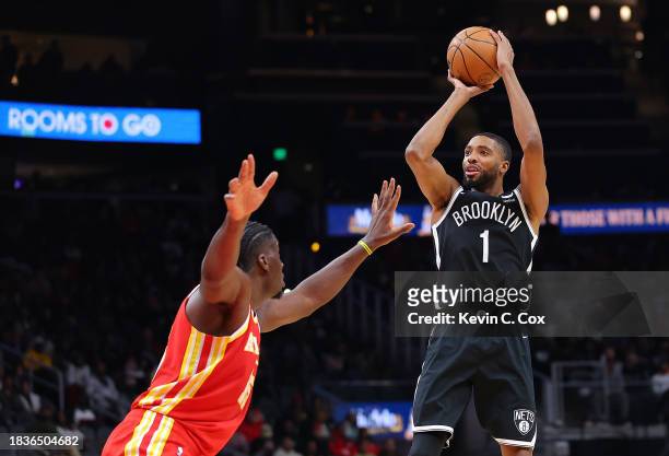 Mikal Bridges of the Brooklyn Nets shoots a basket against Clint Capela of the Atlanta Hawks during the fourth quarter at State Farm Arena on...