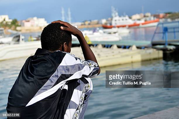 Survivor of the shipwreck of immigrants off the Italian coast looks out over the water of Lampedusa on October 8, 2013 in Lampedusa, Italy. The...