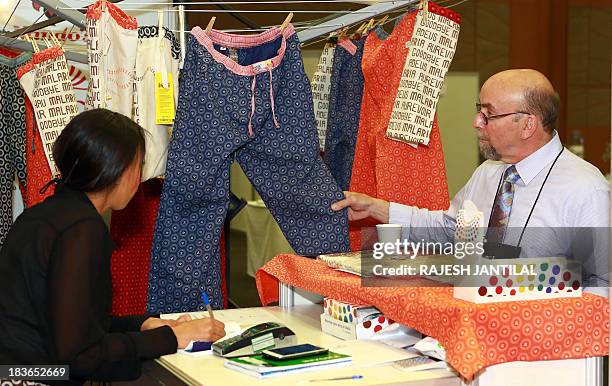 Delegate browses through a "Goodbye Malaria" stall during the 6th MIM Pan-African Malaria Conference held at the International Convention Centre in...