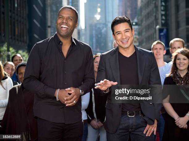 Mario Lopez and AJ Calloway host "Extra" in Times Square on October 8, 2013 in New York City.