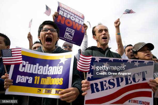 Hernan Morales, a student at American University, and Juan Martinez, cheer during a rally in support of immigration reform, in Washington, on October...