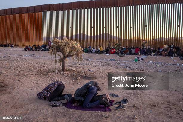 Immigrants from Senegal take part in an Islamic prayer at sunset while waiting with other migrants to be transported from the U.S.-Mexico border on...