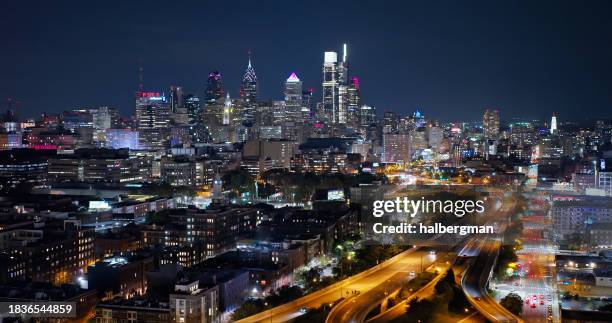 downtown philadelphia skyline with expressway in foreground on cloudy night in fall - interstate 95 stock pictures, royalty-free photos & images
