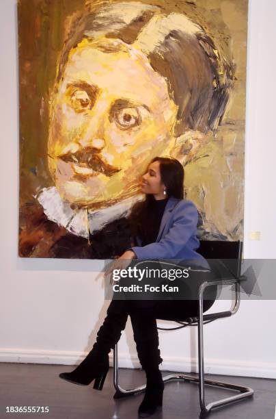 Miss France 2020 Clemence Botino poses with a portrait of Marcel Proust during "Immortels" Petra Marianne Marian's preview at Romanian Cultural...