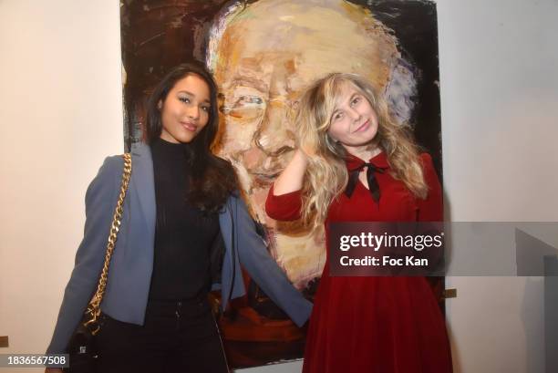 Miss France 2020 Clemence Botino and painter Petra Marianne Marian pose with a portrait of Vladimir Cosma during "Immortels" Petra Marianne Marian's...