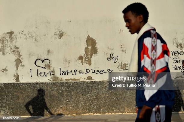 Survivor of the shipwreck off the Italian coast walk in the street of Lampedusa on October 8, 2013 in Lampedusa, Italy. The search for bodies...